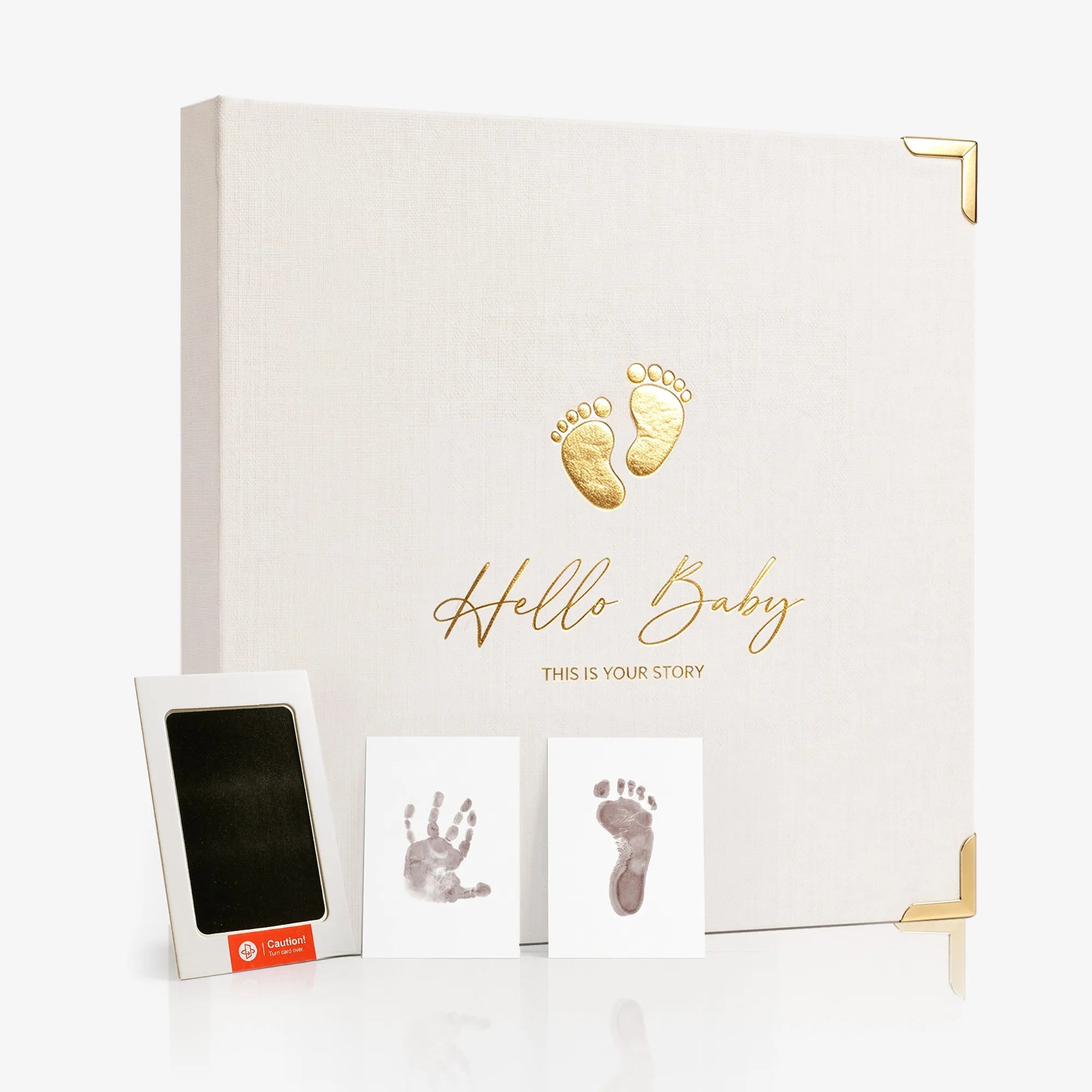 A pristine studio display of the Hello Baby memory book alongside a completed infant handprint and footprint art kit, showcasing an elegant newborn keepsake that makes a perfect baby registry gift.