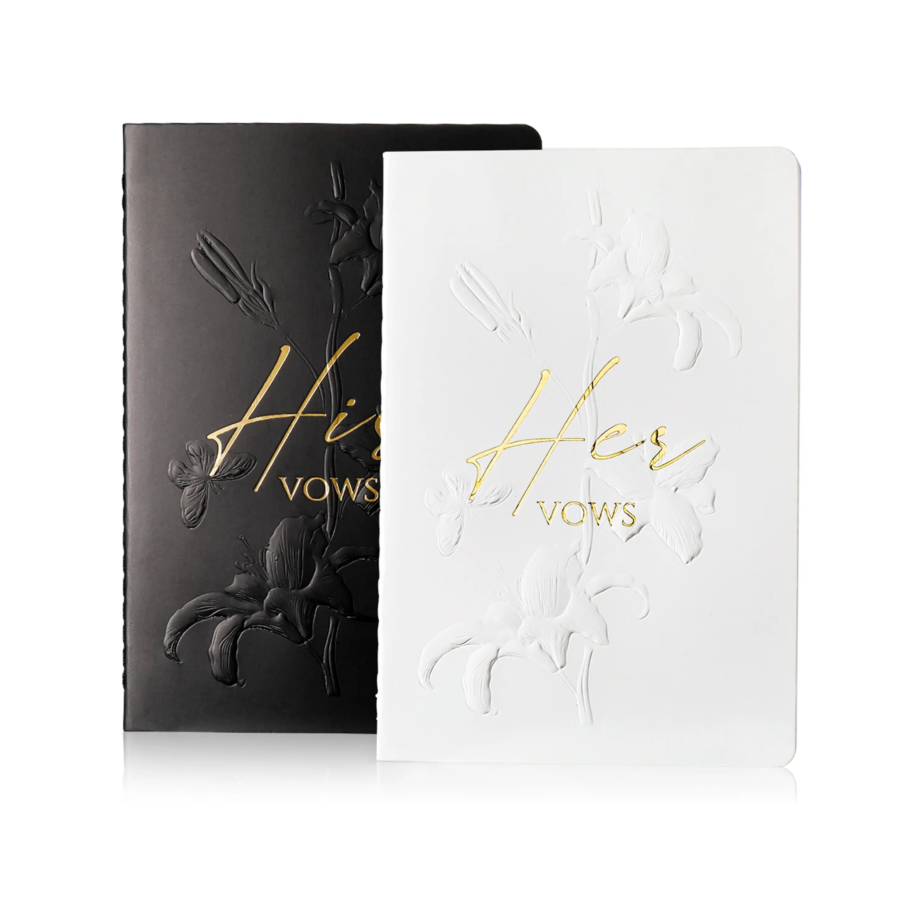 Molekaus botanical embossed wedding vow books in white and black, featuring his and hers designs with sheer ribbons.
