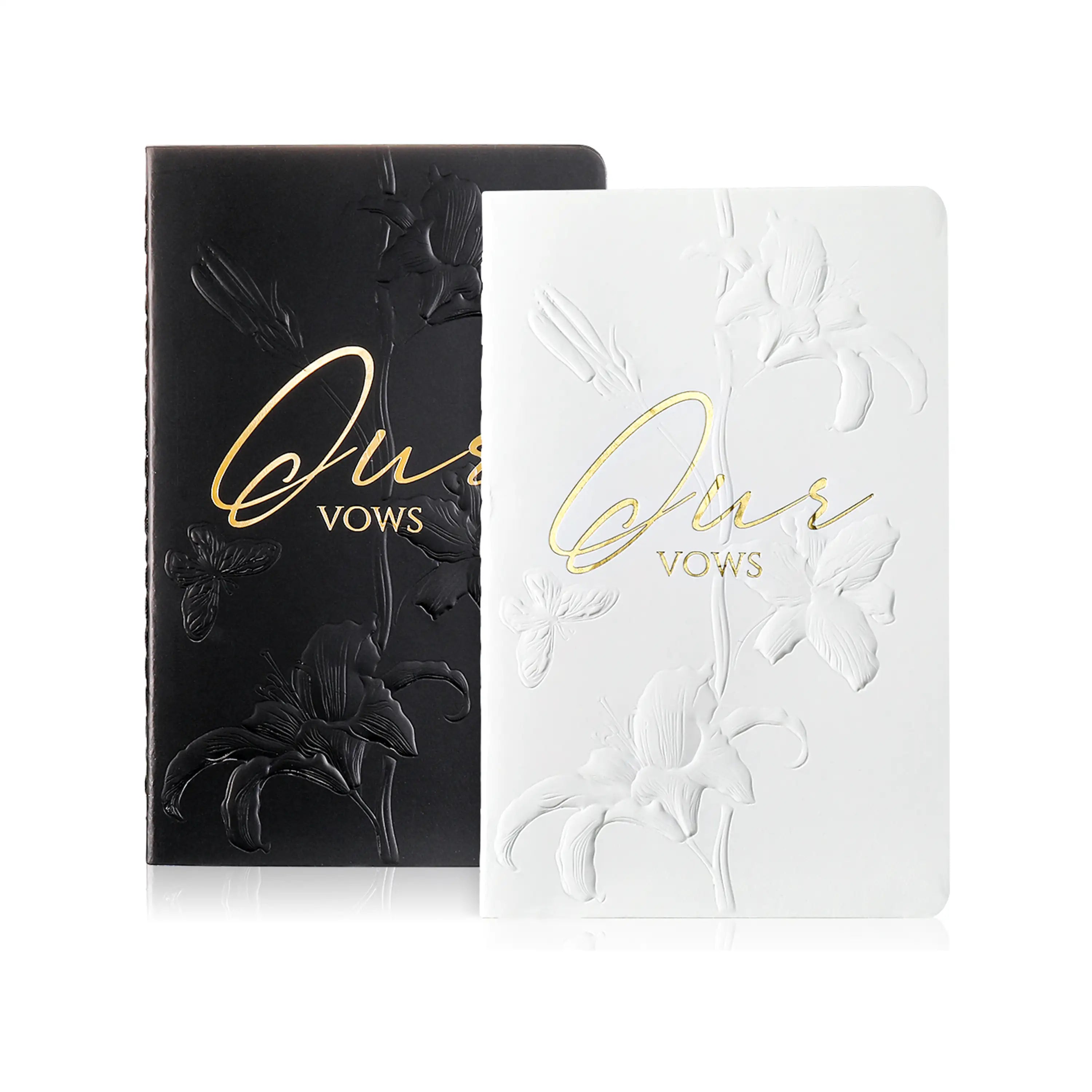 Molekaus genderless wedding vow books in white and black, featuring elegant botanical embossing and 'Ours' lettering.