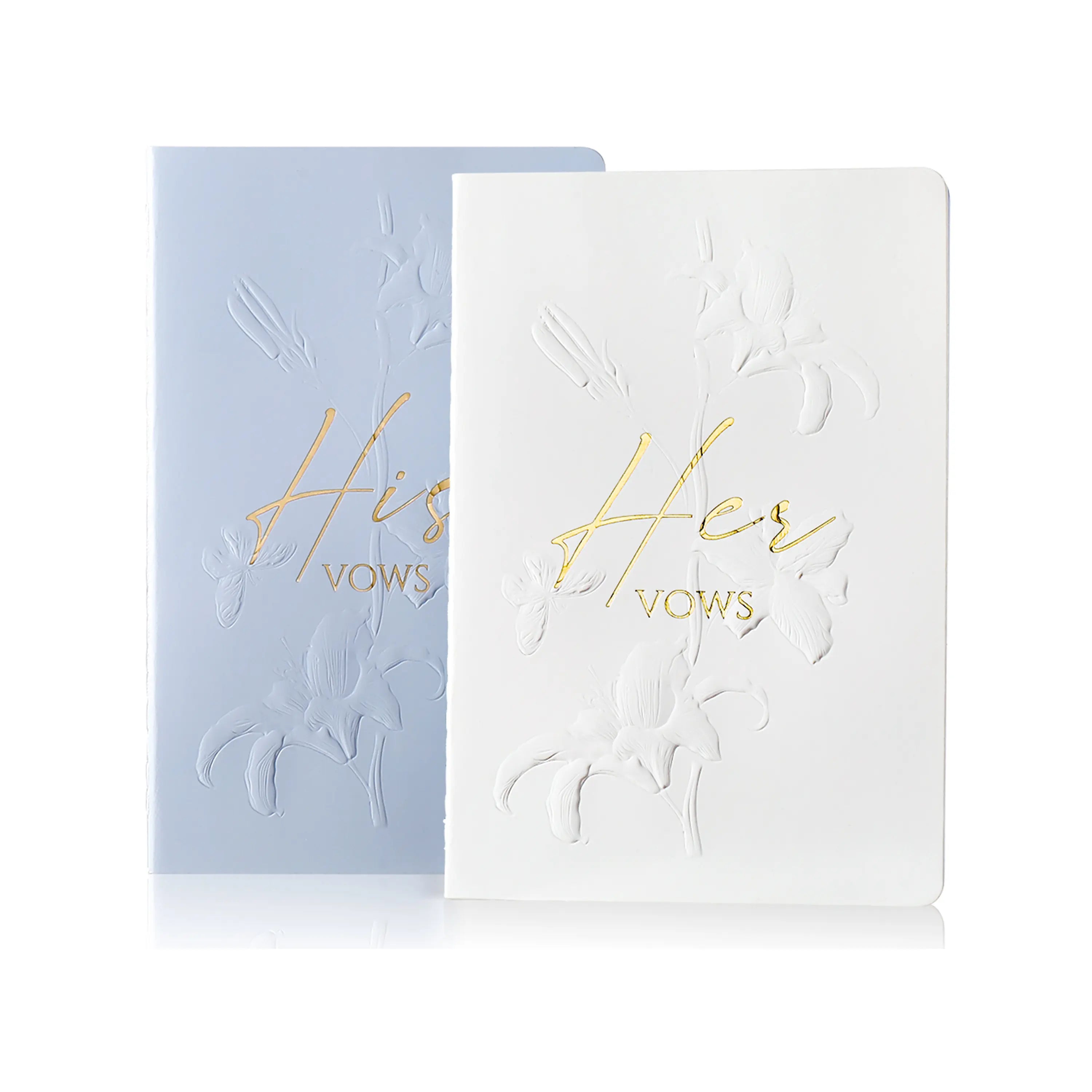 Molekaus floral embossed his and hers wedding vow books in crisp white and elegant blue.
