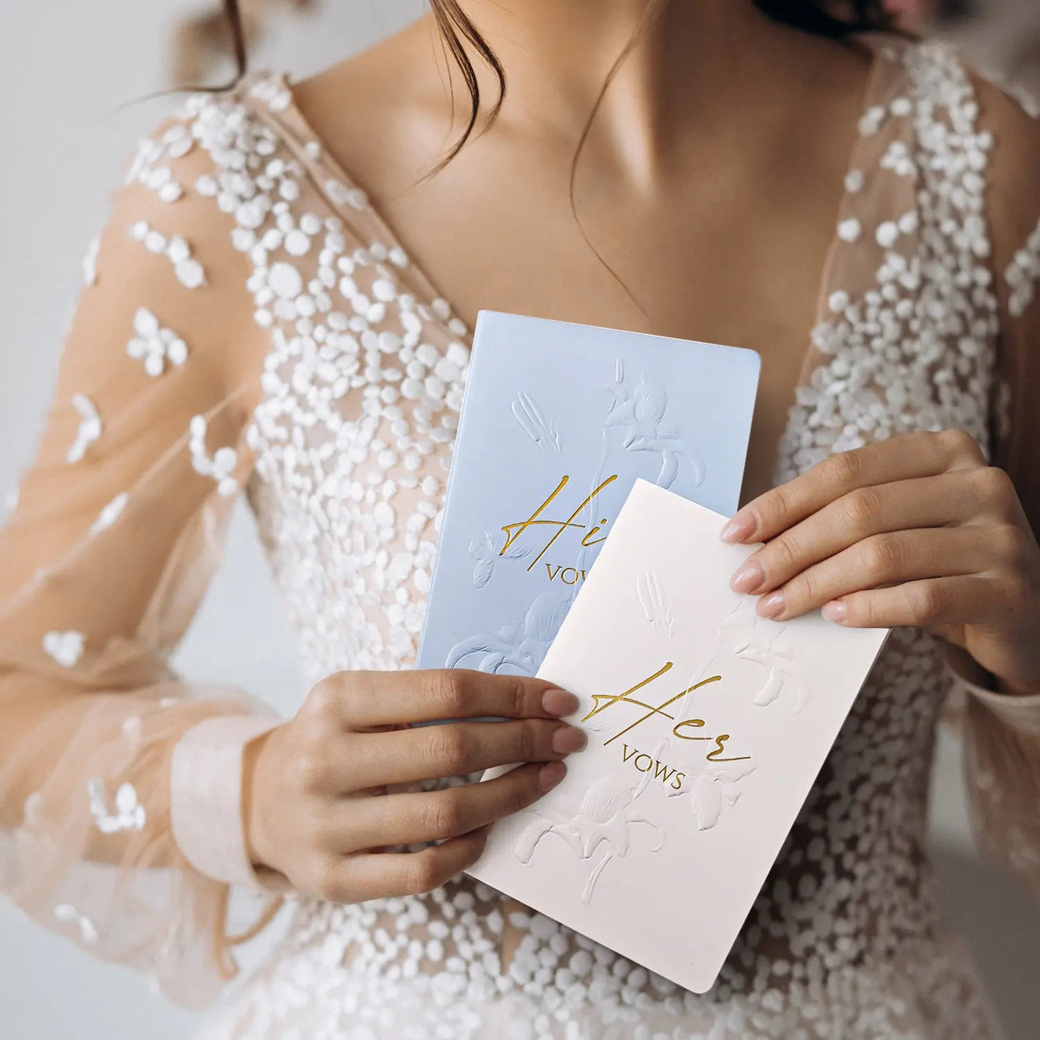 Molekaus floral embossed his and hers wedding vow books in crisp white and elegant blue.