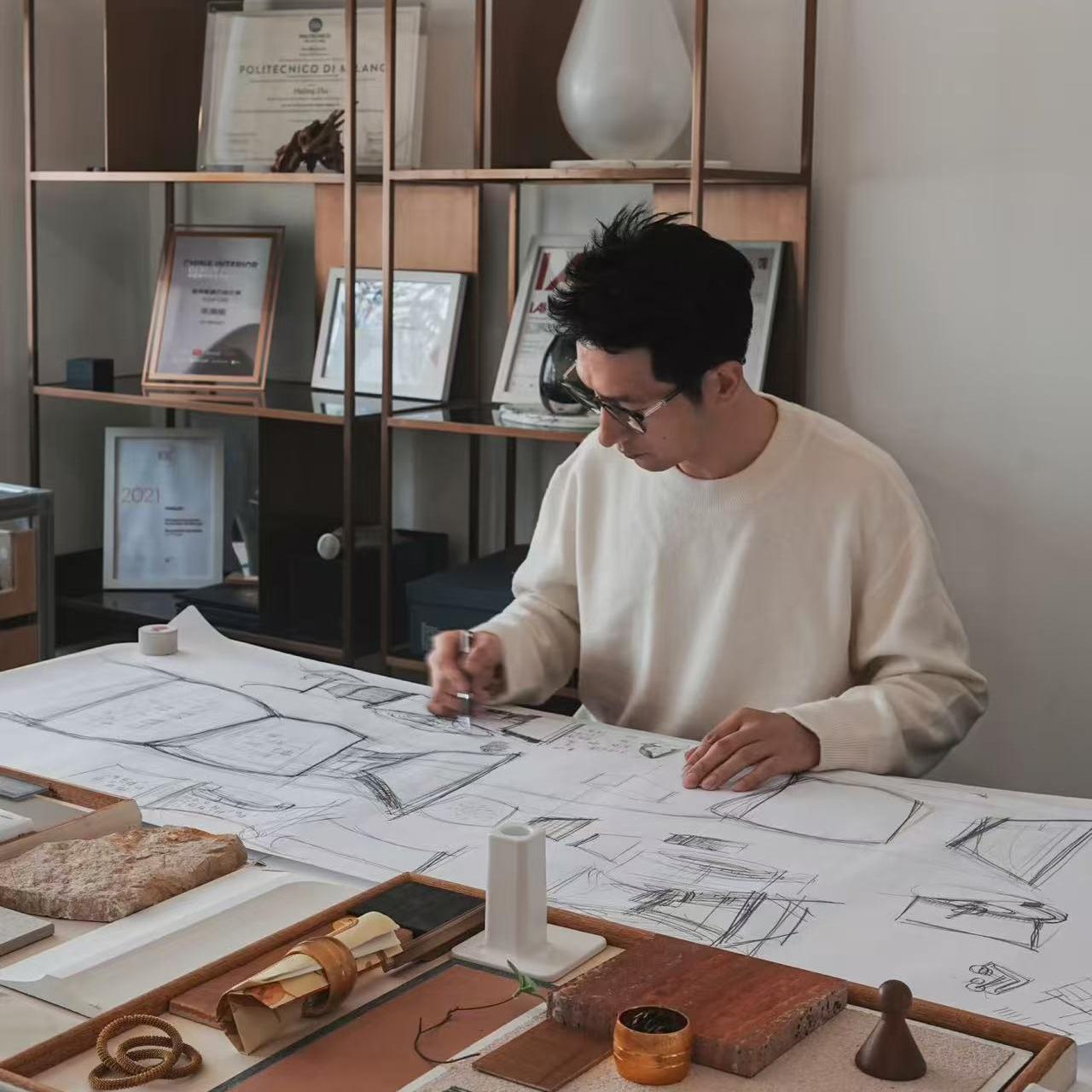 Close-up of a designer's hand sketching intricate botanical illustrations for Molekaus journals on a mobile-friendly view, highlighting our traditional hand-drawn design process.
