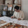 Close-up of a designer's hand sketching intricate botanical illustrations for Molekaus journals on a mobile-friendly view, highlighting our traditional hand-drawn design process.