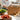 Molekaus premium leather recipe binder open on a rustic kitchen counter, showcasing its practical lay-flat design amidst fresh culinary ingredients.