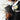 A close-up of a groom in a black suit holding the portable Molekaus black 'His Vows' book, showcasing its compact 6 by 4 inch pocket-size design perfectly crafted to fit into a jacket pocket for the wedding ceremony.