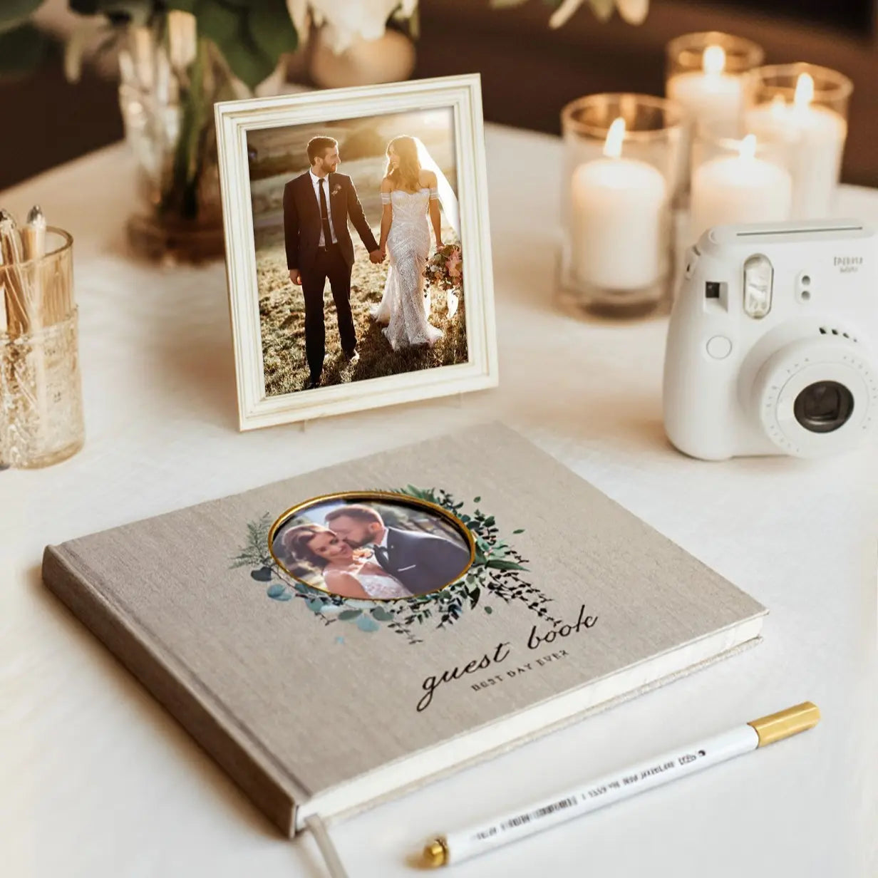 Molekaus polaroid wedding guest book styled on an elegant reception welcome table alongside floral decor.